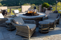 Chairs-and-side-tables-around-fire-pit-in-outdoor-living-space-for-gathering