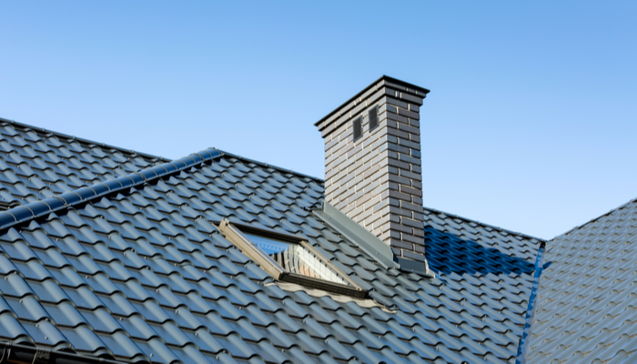 Beautiful gray roof with chimney in he summer