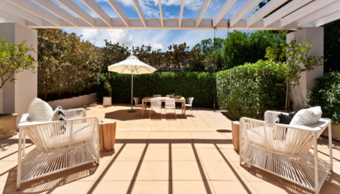Backyard oasis cozy patio area with pergola with wicker furniture set