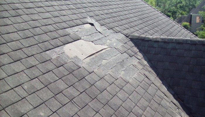 Damaged roof with missing shingles