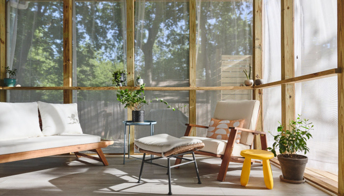 A mid century modern screened in porch int he morning