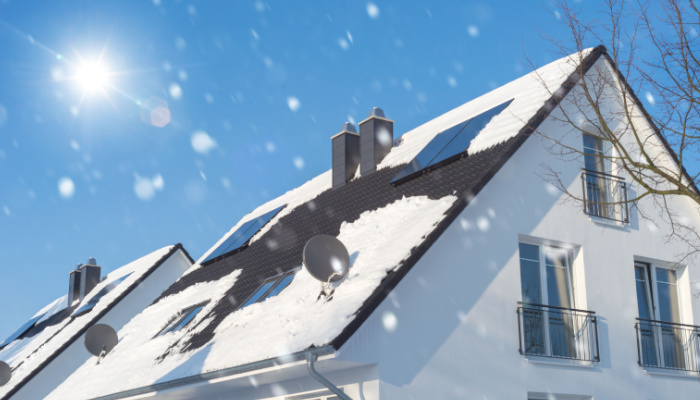 house with solar panel on the roof after snow in winter