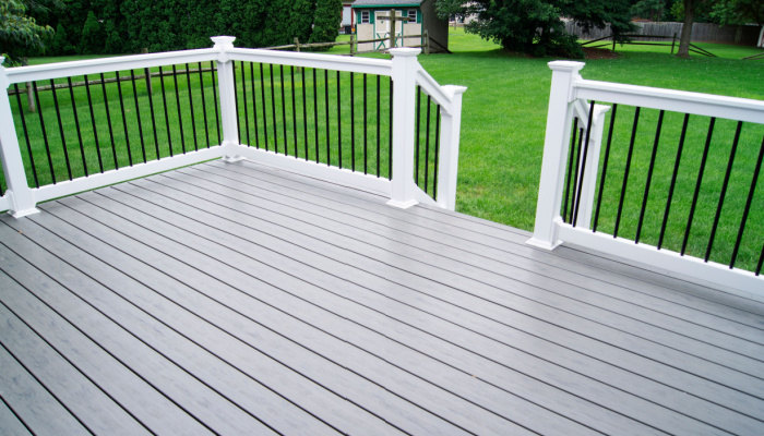 Residential Backyard Gray Composite Deck with grass on the background