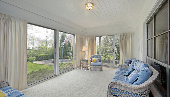 Beautiful wide Sunroom in suburban home with patio view